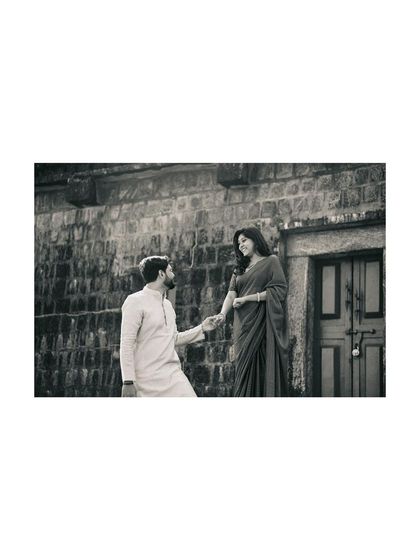 A beautifully framed black and white shot that feels both classic and intimate, capturing a moment of courtship.