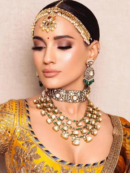 The same mustard yellow bridal look, with eyes closed to showcase the soft, shimmery eyeshadow. This demonstrates the attention to detail in my eye makeup application.