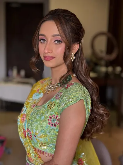 Another angle of the Haldi hairstyle, showing the gentle waves and how the style keeps hair neatly away from the face.