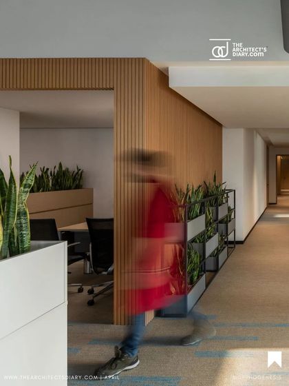 The circulation paths in the Adani office are lined with wood paneling and planters, creating a warm and natural corridor. The design ensures that even transitional spaces contribute to a positive and healthy work environment.