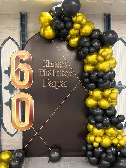 A close-up of the 60th birthday backdrop, showing the personalized "Happy Birthday Papa" message.