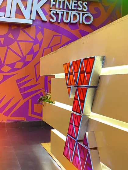 A close-up of our vibrant studio decor and logo. We have designed our space to be energetic and inspiring from the moment you walk in.