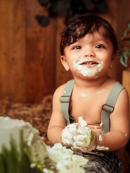 A face full of cake and happiness. This rustic-themed cake smash with a wooden backdrop is perfect for a 'Mr. Onederful' first birthday session.