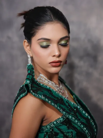A beautiful shot with eyes closed, giving a clear view of the graphic green eyeliner.