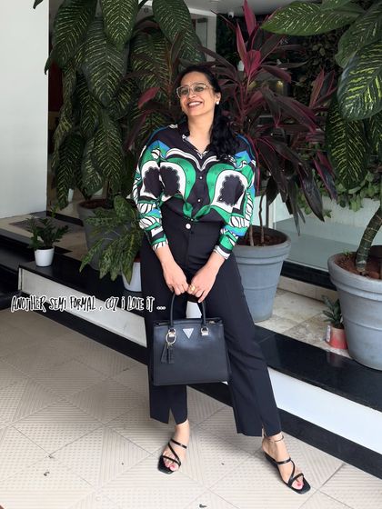 A bold and stylish semi-formal look featuring a printed shirt and black trousers. This outfit is perfect for a creative professional, showcasing a confident and fashion-forward style.