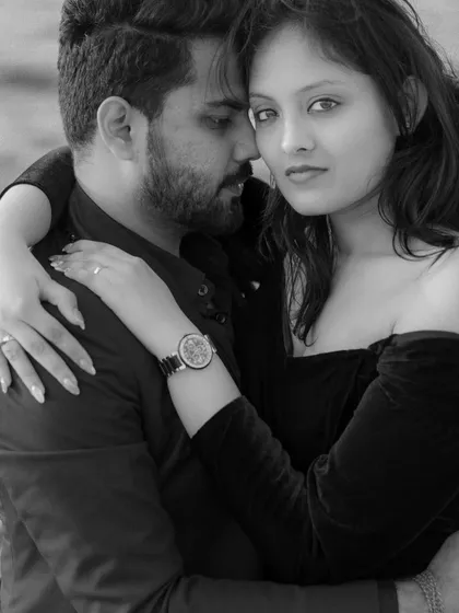 A powerful black and white portrait from a Dubai pre-wedding shoot. Stripping away the color allows the raw emotion and connection to take center stage. Her direct gaze and his closeness create a captivating and intimate image.
