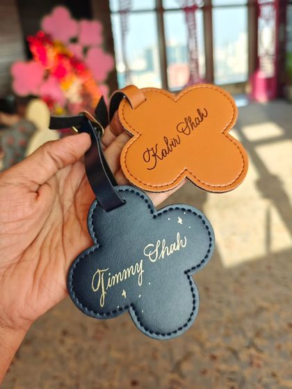 More examples of the personalized luggage tags from the live event, showcasing different names and tag colors.