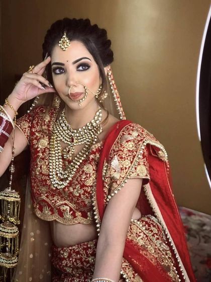 Our client looking gorgeous in a classic red velvet lehenga with gold embroidery. The layered pearl necklace adds a touch of vintage glamour to her D-day look.