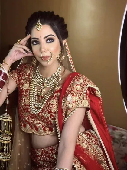 Our client looking gorgeous in a classic red velvet lehenga with gold embroidery. The layered pearl necklace adds a touch of vintage glamour to her D-day look.