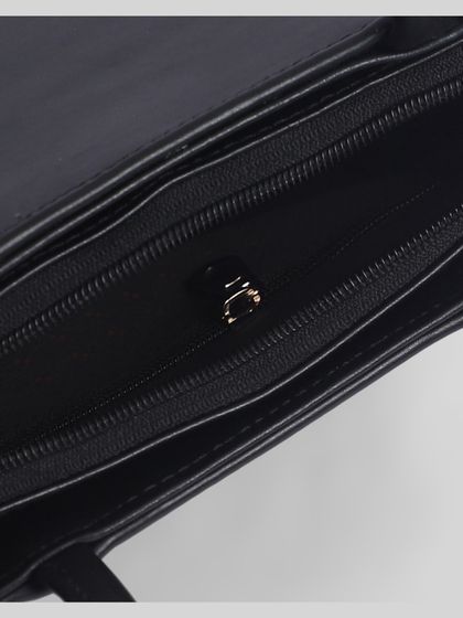 A close-up of the black bag's inner pocket and zipper.