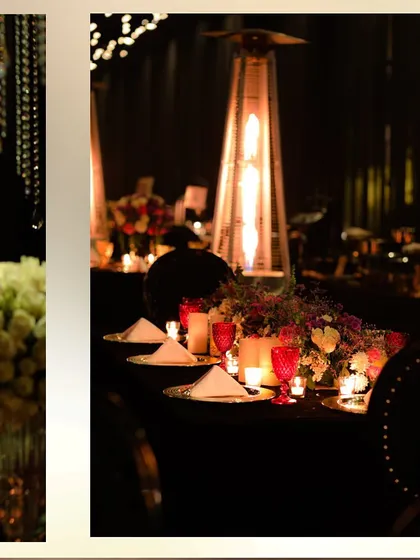 A close-up of a table setting, showing the combination of a floral centerpiece, red glassware, and the warm glow of a patio heater.