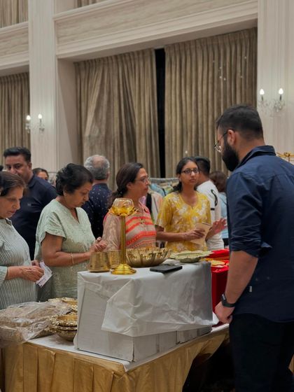 An evening crowd gathers around a food stall, showing that the event stays lively from afternoon until closing time.