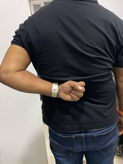 Here is the significant improvement in Mr. Hukum's ability to reach behind his back after several sessions, showing increased flexibility and reduced pain.