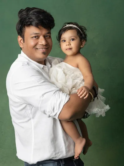 A father's gentle hold. This simple, classic portrait of a dad and his daughter is filled with so much love and tenderness.