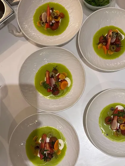 A line-up of the crab and gazpacho dish, ready for service. The consistency across all plates is a hallmark of a professional kitchen.