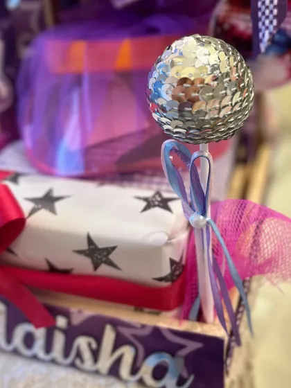 A mini disco ball wand adds a touch of glam and fun, perfectly capturing the popstar vibe.