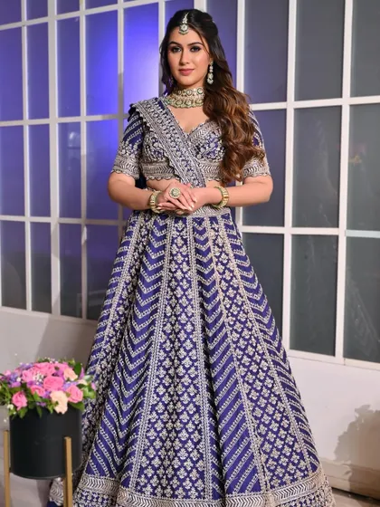 A full-length shot of the festive blue lehenga look. The makeup is designed to be bold and beautiful, matching the energy of the celebration.