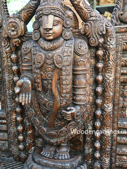 A close-up of the upper body of the 79-inch Lord Venkatajalapathy statue. The dark, polished finish accentuates the fine details of the deity's ornaments and the serene power of his form.