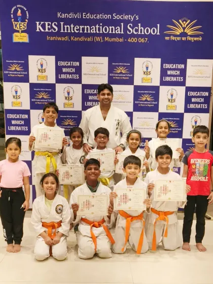 A full group shot with me and my students at KES International School. Seeing the smiles on their faces after a successful belt ceremony is the best reward for an instructor.