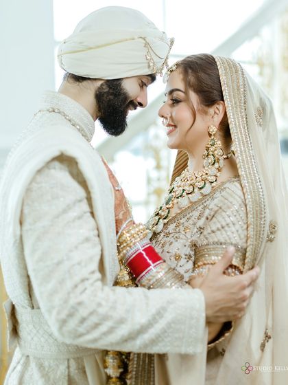 A close-up shot of the bride and groom sharing a happy and intimate moment during their Anand Karaj ceremony.