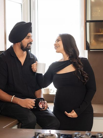 A candid conversation over coffee. This shot captures the easy, natural interaction between the couple in their kitchen, a real-life moment frozen in time.