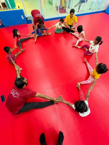 A heart-shaped stretch circle. This image beautifully captures the spirit of my gym, where kids and instructors connect and work together, building a strong and supportive community.