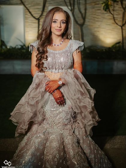 Surbhi posing in her stunning sangeet outfit. The makeup complements her dusky skin tone beautifully, giving her a radiant and ethereal glow.