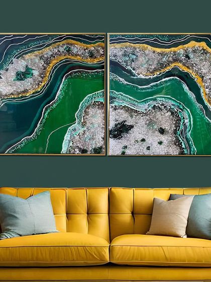This set of two resin art paintings uses a vibrant emerald green, contrasted with silver and gold crystalline textures. It's a bold and beautiful statement piece for a modern living room.