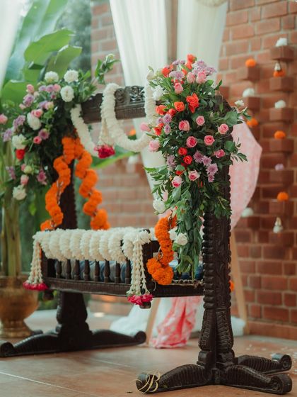 The beautifully decorated cradle, or 'thottilu', is the centerpiece of the naming ceremony. We adorned it with lush floral arrangements and traditional garlands of marigold and jasmine.