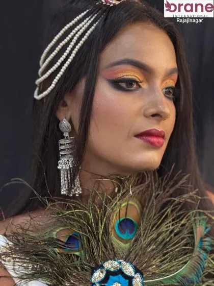 This shot showcases the full look, including the statement silver jewelry and pearl headpiece.