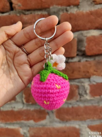Sweet strawberry and daisy keychains. These come in red, pink, and purple, each with a little white flower.