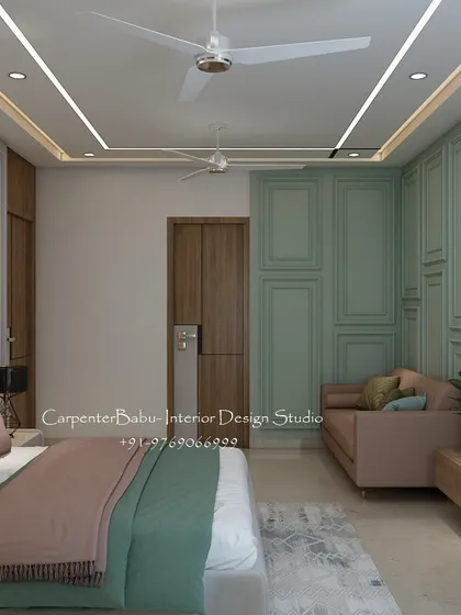 A bridal bedroom designed with a soft and romantic palette of sage green and dusty pink. The wall paneling and cozy loveseat create a space that is perfect for a new beginning.