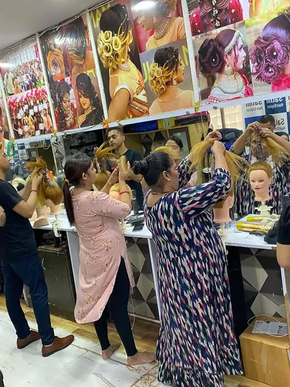 This is my academy in action. You can see a full class with every student working hands-on, because I believe practice is the only way to become a true hairstyling artist.
