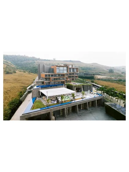 The stunning Aria Resort in Nashik, a modern architectural marvel set against rolling hills, provided a unique backdrop for this carnival-themed wedding celebration.