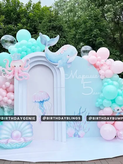 I brought an underwater fantasy to life with this pastel "Under the Sea" birthday theme. The scene is set with arched backdrops, detailed cutouts of a whale, octopus, and jellyfish, and beautiful balloon garlands in shades of aqua and pink to mimic ocean corals.