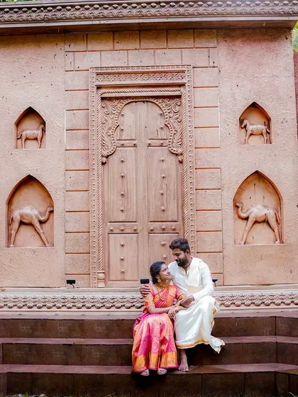 A quiet, intimate moment for a couple in traditional attire at our desert-themed stepwell set.