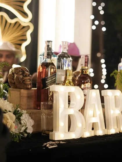 Let the night be-gin. A close-up of the illuminated 'BAR' sign, creating a cool and inviting focal point for the cocktail station.