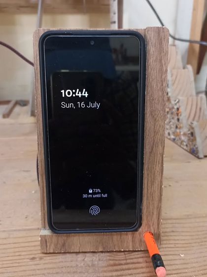 The wireless charging stand in action. The design is minimal and functional, keeping the phone upright and charging without messy cables in the front.