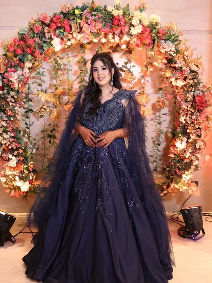 Another angle of the client in the navy gown, looking poised and elegant. I ensure every outfit is tailored to provide a flattering and comfortable fit.