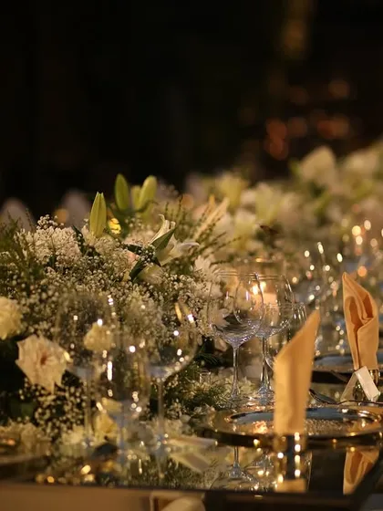 The tablescape at dusk, with the candles lit and the sky as a backdrop. The mirrored surface beautifully captures the transition from day to night.
