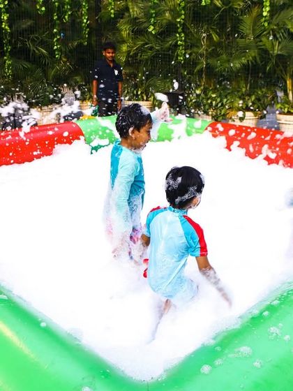 A foam pit filled with happy kids. This is a consistently popular feature that brings a unique element to any pool party.