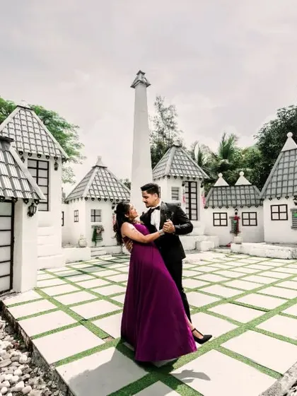 For couples looking for something unique, a pre-wedding set offers a world of creative possibilities. Here, a whimsical, European-style village backdrop provides a playful and fairytale-like setting for a romantic dance.