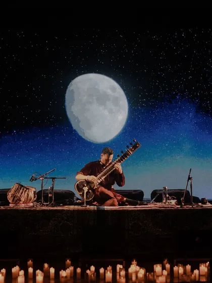 Performing under a stunning visual of the moon. The cosmic and natural imagery I use is meant to evoke a sense of wonder and connection to something larger than ourselves.