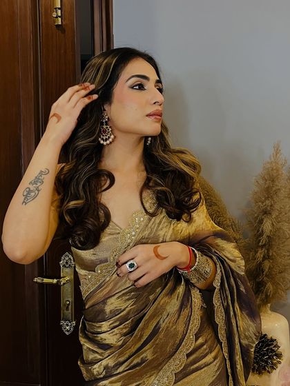 A close-up of the golden tissue saree I designed for my brother's sangeet. I focused on a lightweight, shimmering fabric and paired it with antique-style jewelry.