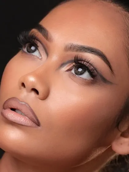 An artistic angle that highlights the clean lines and structure of the makeup.