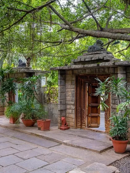 Every path here is an invitation to explore. This walkway, lined with stone pillars and lush plants, leads to another of the venue's hidden gems.