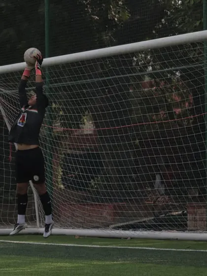 A goalkeeper in full flight, making a crucial save. Our last line of defense is always ready.
