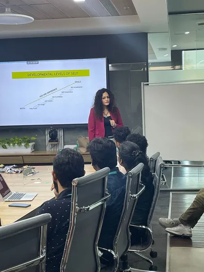 Explaining the 'Developmental Levels of Self' during a training session. This psychological framework helps participants understand their own journey of growth and how it relates to their personal and professional image.