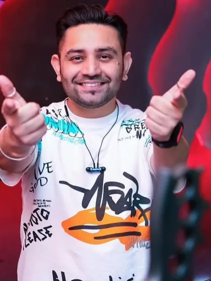 Pointing at the camera, inviting you to join the party.
