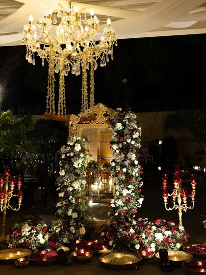 Another view of the grand floral mirror installation, this time with a crystal chandelier, adding to the opulence of the Sangeet night.